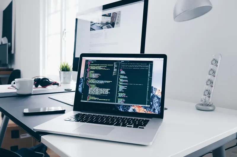A laptop with code, on a desk